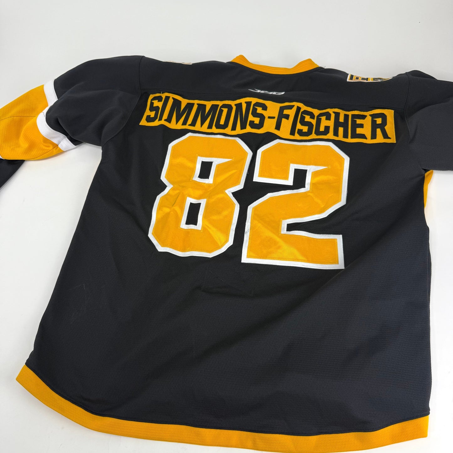Black JOG Adrian College Game Jersey | Size 56 | Simmons-Fischer #82 - Top Flight Hockey