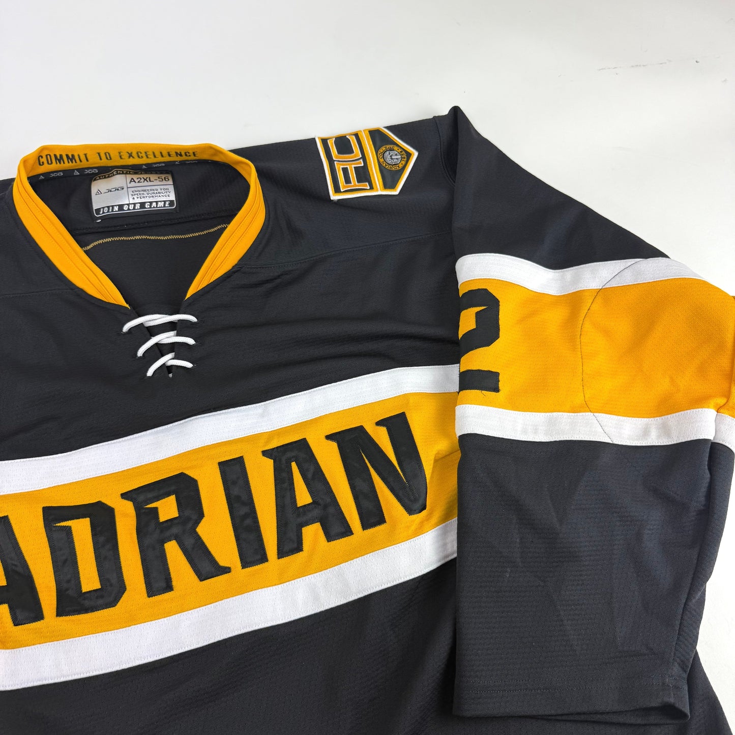 Black JOG Adrian College Game Jersey | Size 56 | Simmons-Fischer #82 - Top Flight Hockey