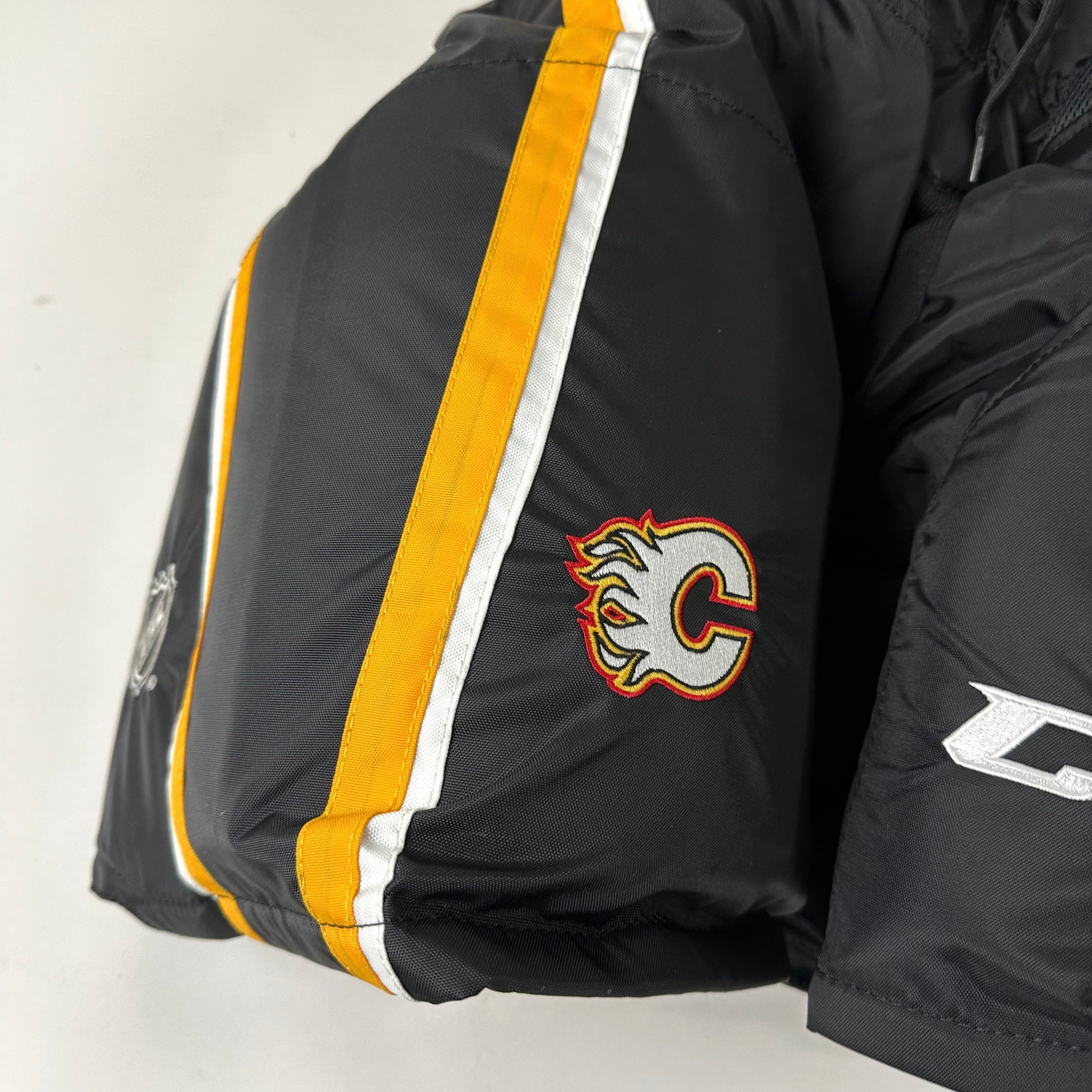 Brand New CCM HPTKXP Pro Pants - Third Calgary Flames - Large +1" - Top Flight Hockey